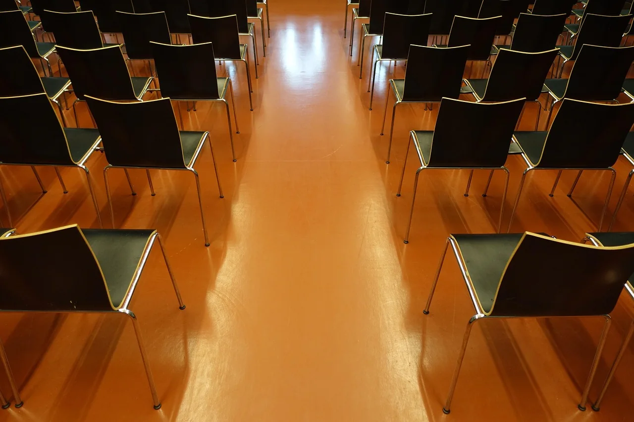 Rows of auditorium seats arranged around a central aisle